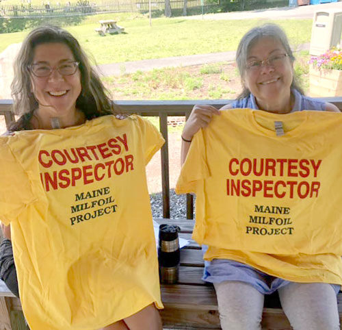 women holding courtesy inspector shirts